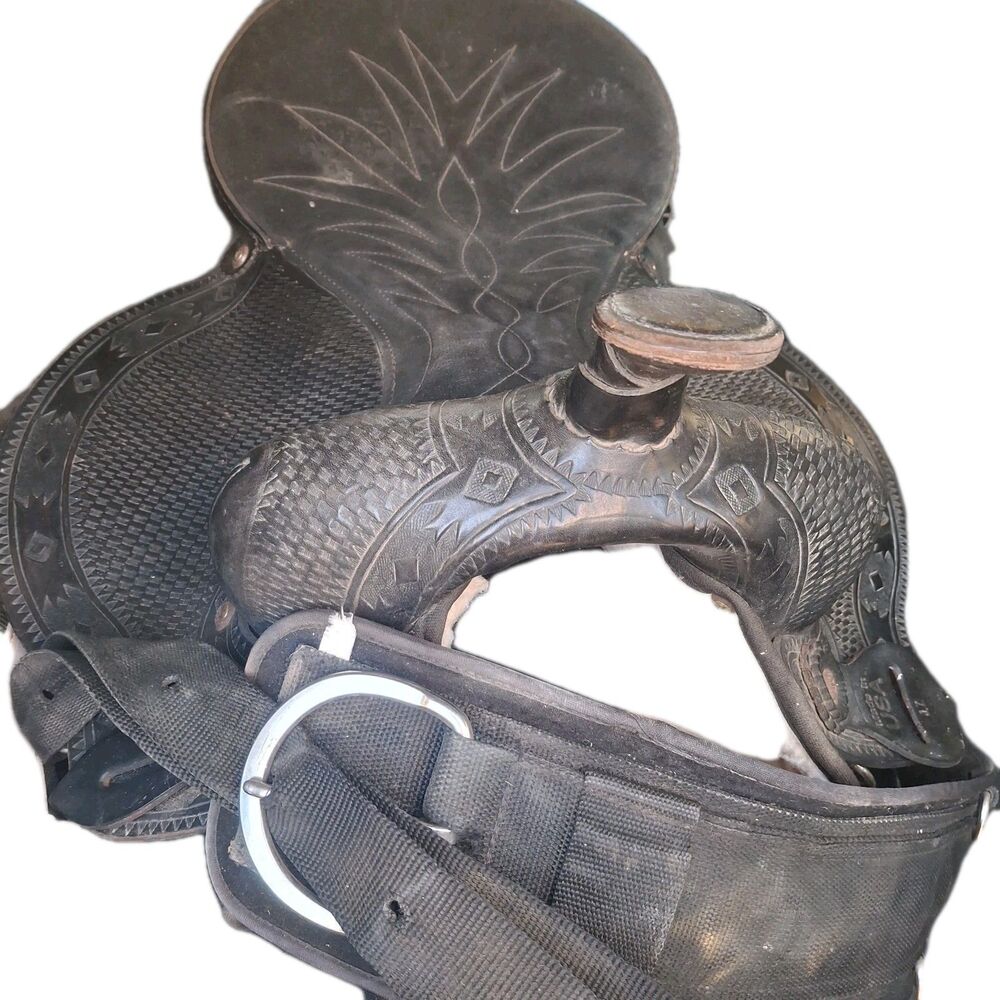 Black leather western horse saddle with deep seat and floral tooling.